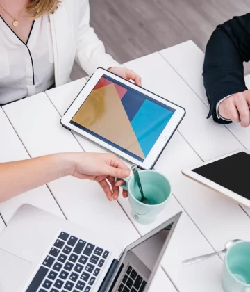 crop-businesspeople-with-gadgets-desk